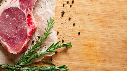 Image showing Pieces of crude meat with rosemary and spices