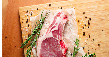 Image showing Pieces of crude meat with rosemary and spices