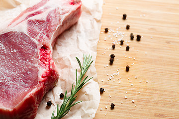 Image showing Pieces of crude meat with rosemary and spices