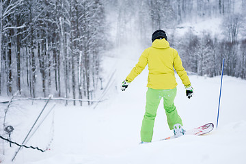 Image showing Snowboarder riding on background beautiful mountain landscape