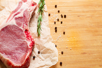 Image showing Pieces of crude meat with rosemary and spices