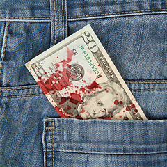 Image showing Macro shot of trendy jeans with american 20 dollar bill, blood