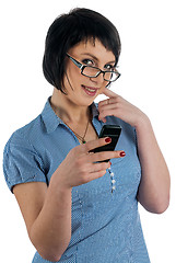 Image showing Pretty woman smiles with phone in hand