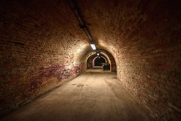 Image showing Long underground brick tunnel angle shot