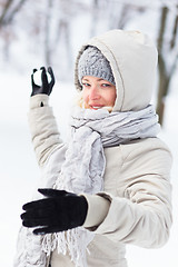 Image showing Girl snowball fighting in winter time.