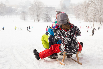 Image showing Winter fun, snow, children sledding at winter time.