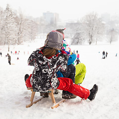 Image showing Winter fun, snow, children sledding at winter time.