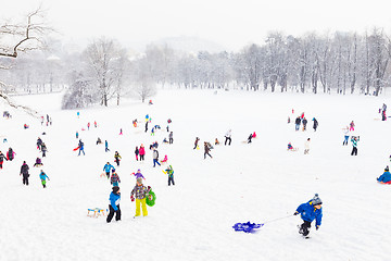 Image showing Winter fun, snow, family sledding at winter time.