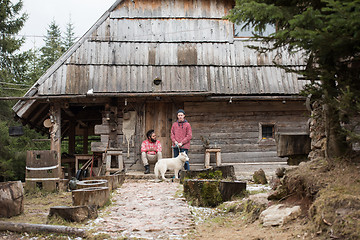Image showing frineds together in front of old wooden house