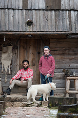 Image showing frineds together in front of old wooden house