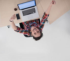 Image showing top view of young business woman working on laptop