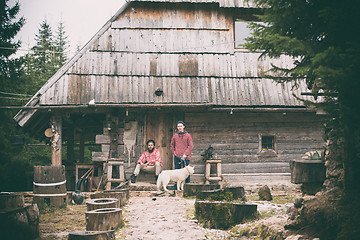 Image showing frineds together in front of old wooden house