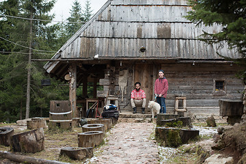 Image showing frineds together in front of old wooden house