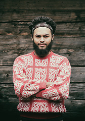 Image showing portrait of young hipster in front of wooden house