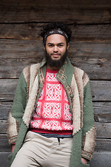 Image showing portrait of young hipster in front of wooden house