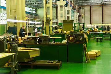 Image showing Elderly mechanic works in shop