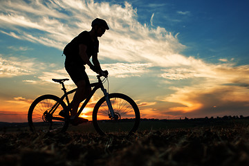 Image showing Silhouette of a man on muontain-bike