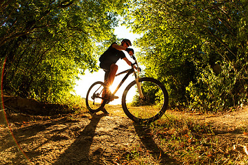 Image showing Man Cyclist with bike on sunset