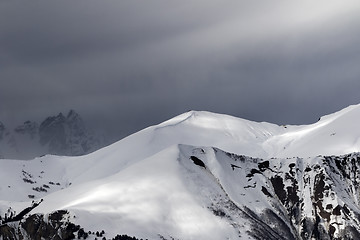 Image showing Sunlight mountains with snow cornice and trace from avalanche be