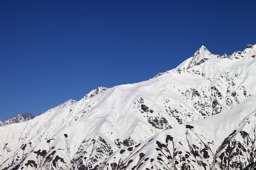 Image showing Snowy mountain peaks and blue clear sky