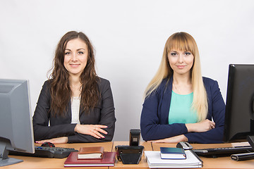 Image showing Two young girls sitting at a colleague office table is divided into two jobs