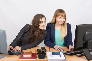 Image showing She looked at his colleague computer screen at work in the office