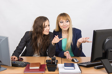 Image showing Two colleagues in the office to discuss the electronic document in a computer screen