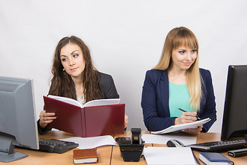 Image showing Two business women working with one rival desktop