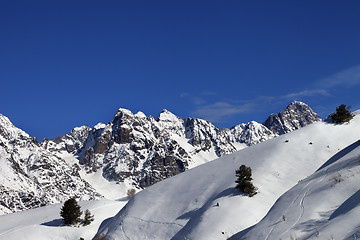 Image showing Off-piste slope with track from ski and snowboard on sun day