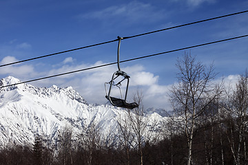 Image showing Chair lift in snowy mountains at nice day