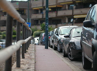 Image showing sidewalk and line of cars leaving afar