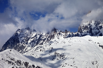 Image showing Snowy rocks in haze at sunny day