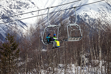 Image showing Father and daughter on chair-lift at nice sunny day