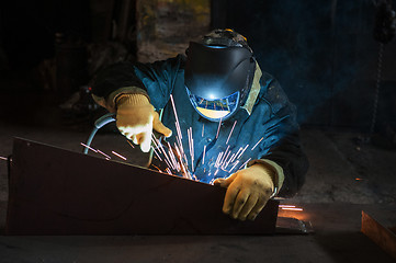 Image showing worker welding metal