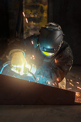 Image showing worker welding metal