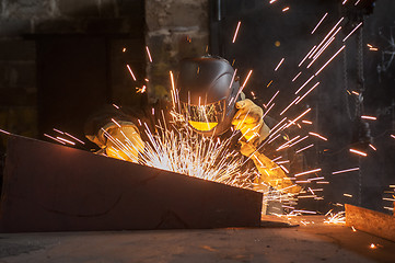 Image showing worker welding metal