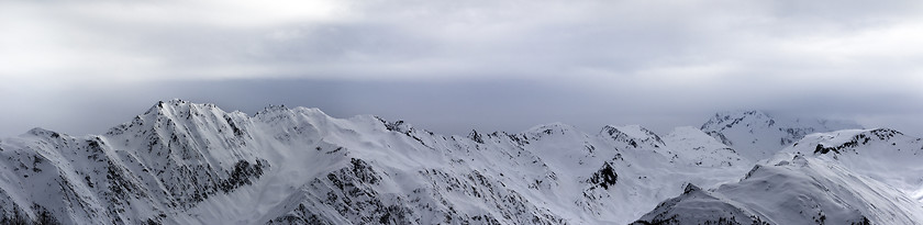 Image showing Panoramic view on high snowy mountains and sunlight storm sky be