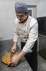 Image showing Chef Cutting the Pizza