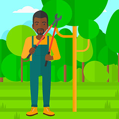 Image showing Farmer with pruner in garden.