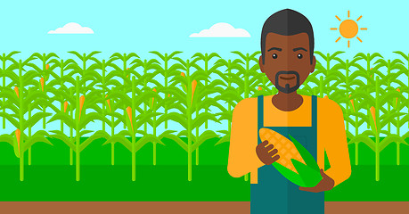 Image showing Farmer holding corn.