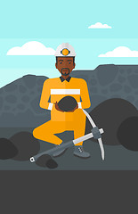 Image showing Miner holding coal in hands.