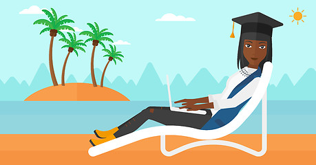 Image showing Graduate lying on chaise lounge with laptop.