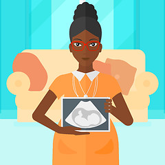 Image showing Pregnant woman with ultrasound image.