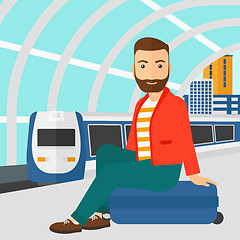 Image showing Man sitting on railway platform.