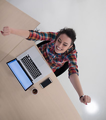 Image showing top view of young business woman working on laptop