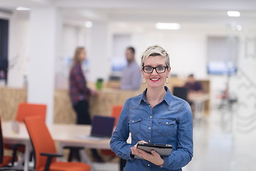 Image showing portrait of young business woman at office with team in backgrou