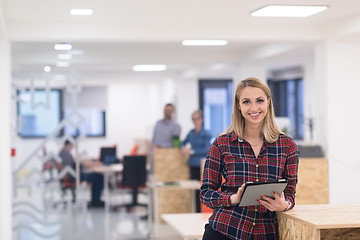 Image showing portrait of young business woman at office with team in backgrou