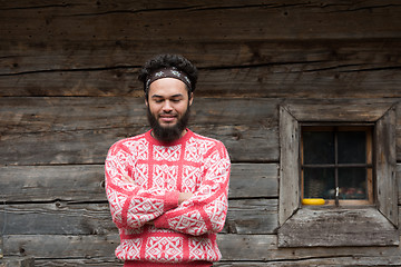 Image showing portrait of young hipster in front of wooden house