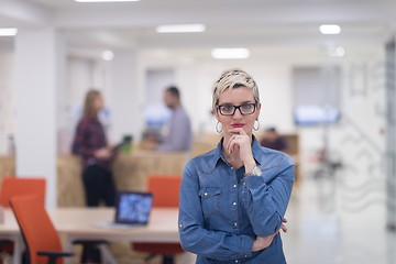 Image showing portrait of young business woman at office with team in backgrou