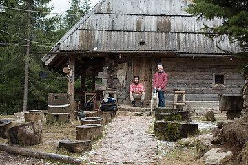 Image showing frineds together in front of old wooden house